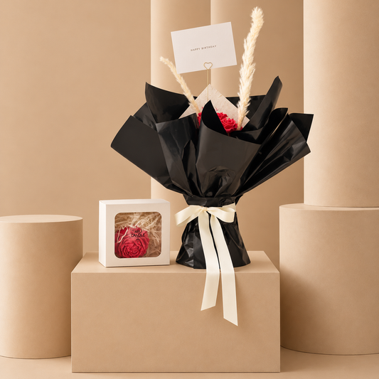 Red rose candle bouquet in black wrapping with pampas grass – Velvet Ember by Aru Candle Dubai